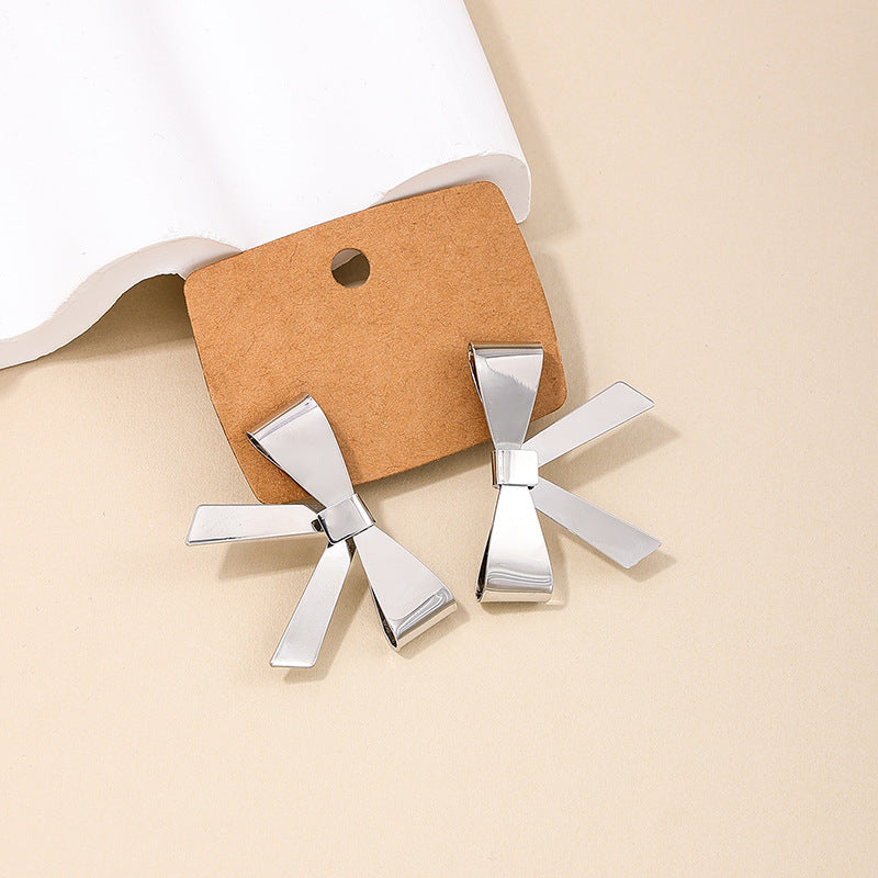 Exaggerated Bow Embellished Metallic Earrings with a Touch of European Flair