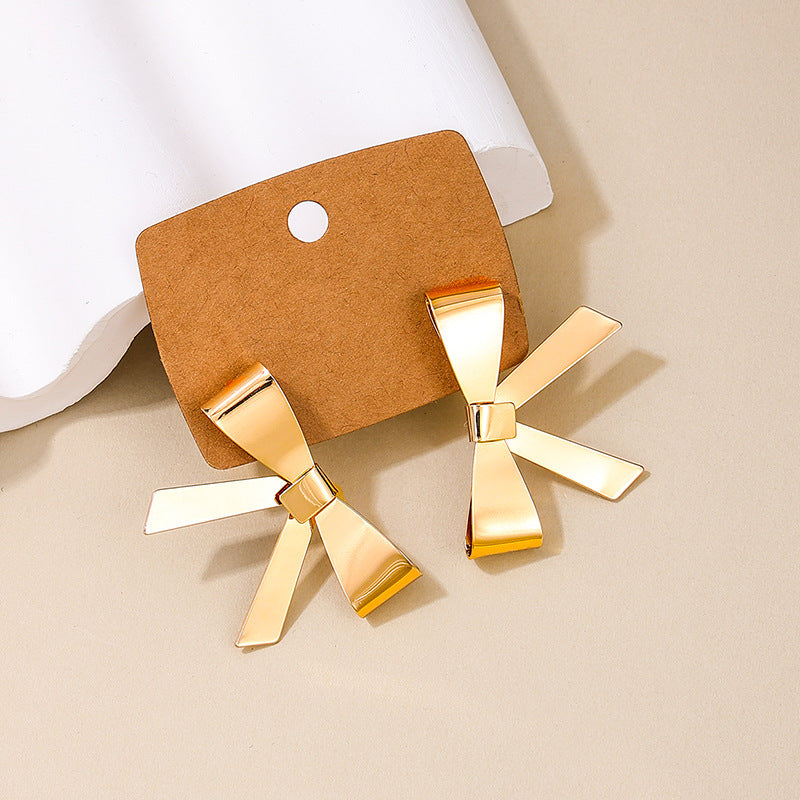 Exaggerated Bow Embellished Metallic Earrings with a Touch of European Flair