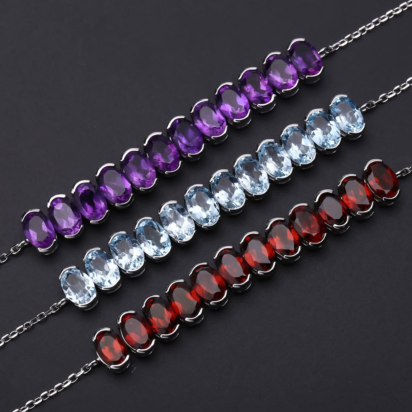 A Row of 12 Oval Shape Gemstones Silver Bracelet