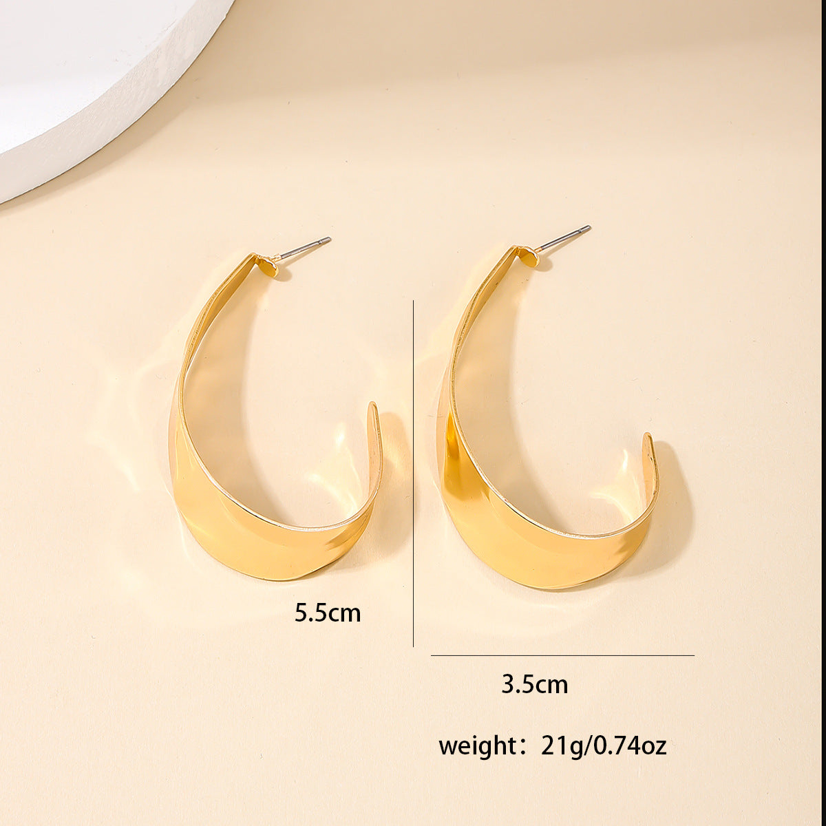 Exaggerated Metallic Crescent Earrings with a Retro Twist