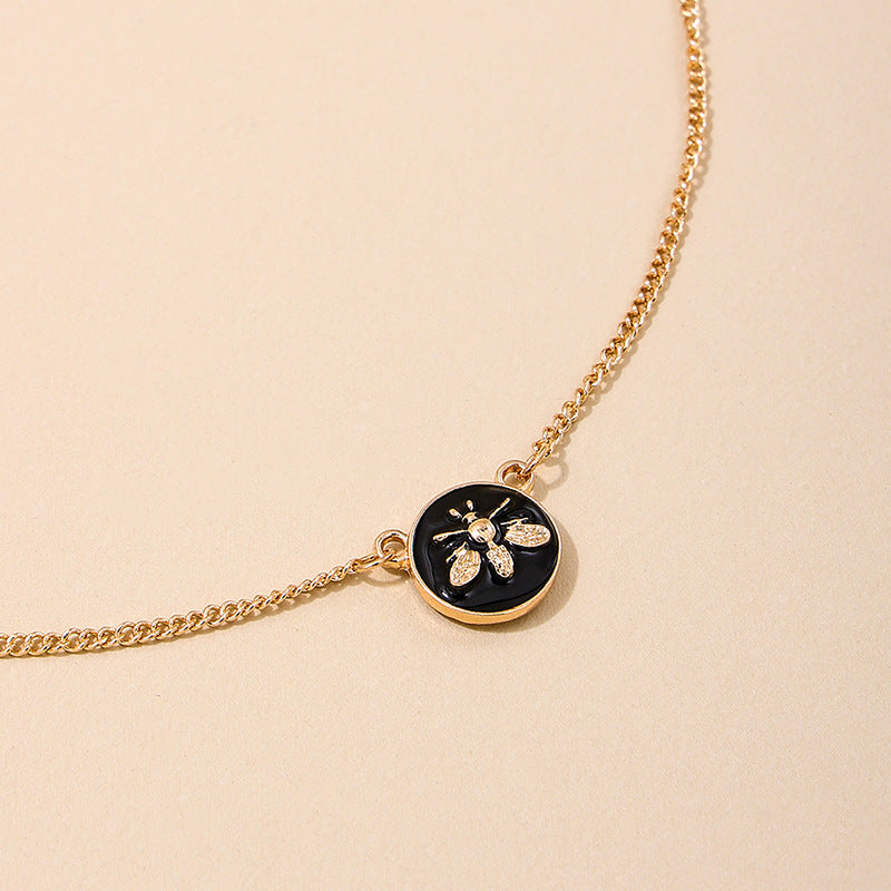 Elegant Black Circle Pendant Necklace with Bee Accent