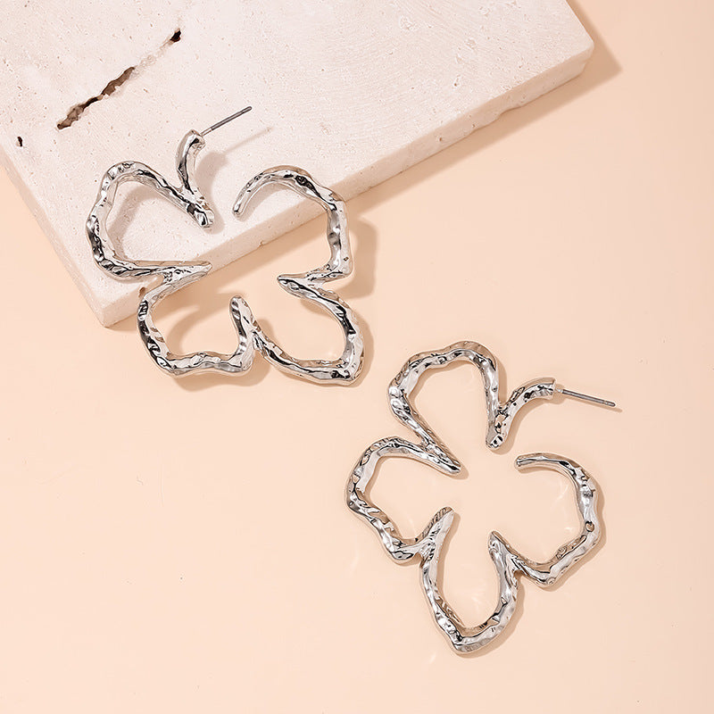 Stylish Vienna Verve Metal Earrings with Irregular Hollow Flower Design for Wholesale.