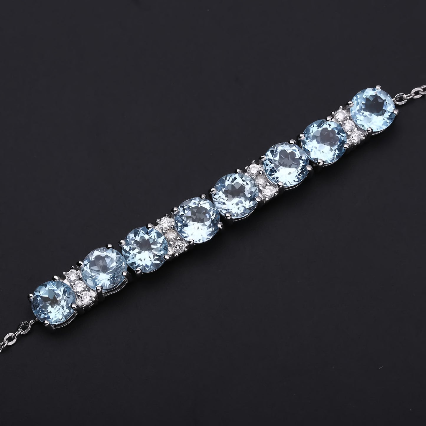 Row of Round Cut Natural Blue Topaz Silver Bracelet