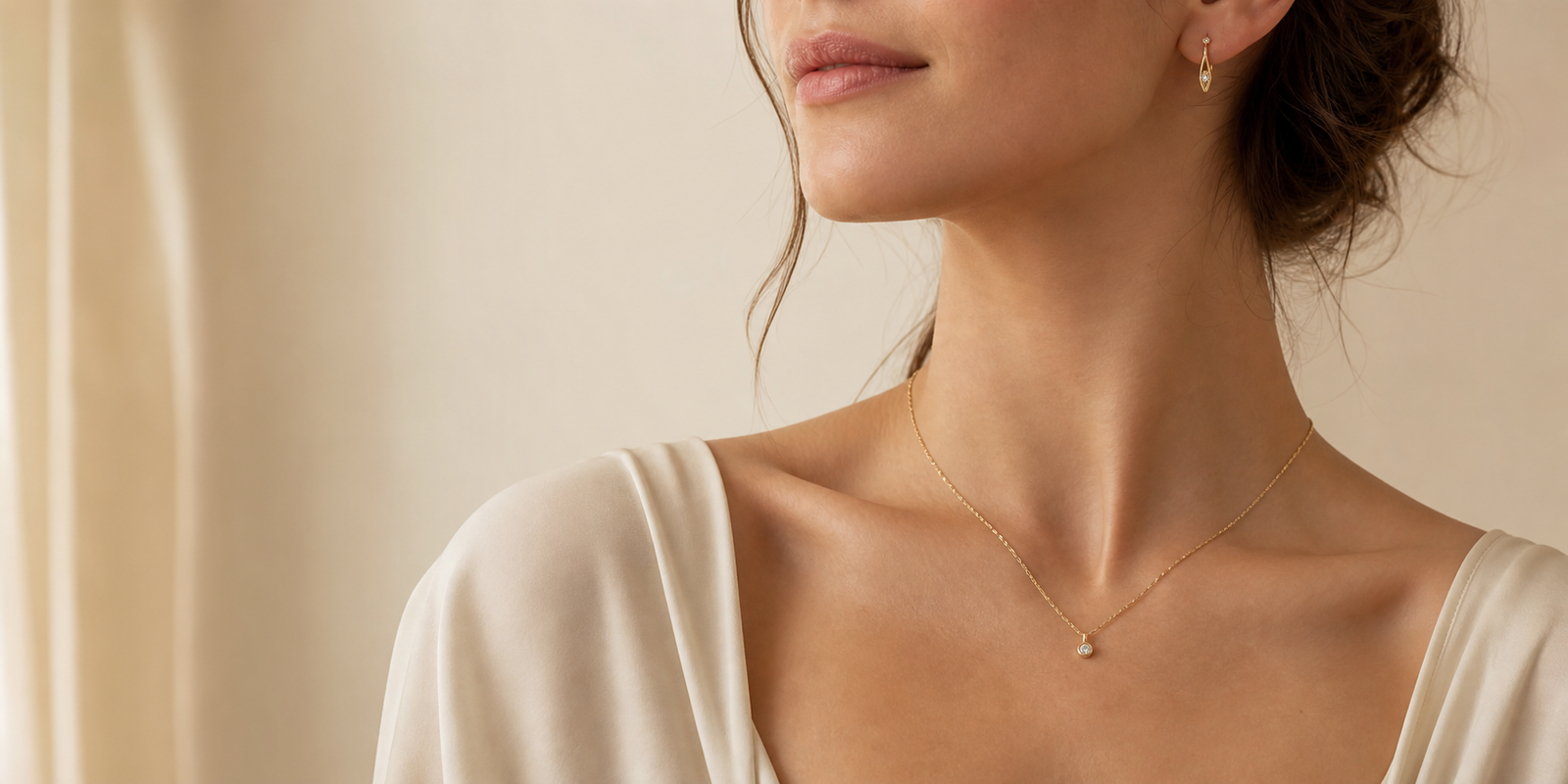 Woman wearing a delicate gold necklace and earrings