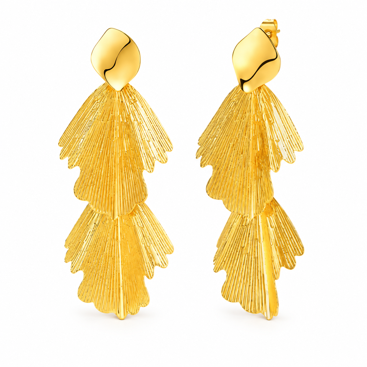 Gold-tone cascading ginkgo leaf statement earrings on white background