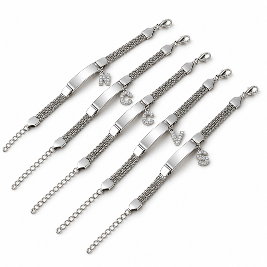 Silver initial chain bracelets on a white background