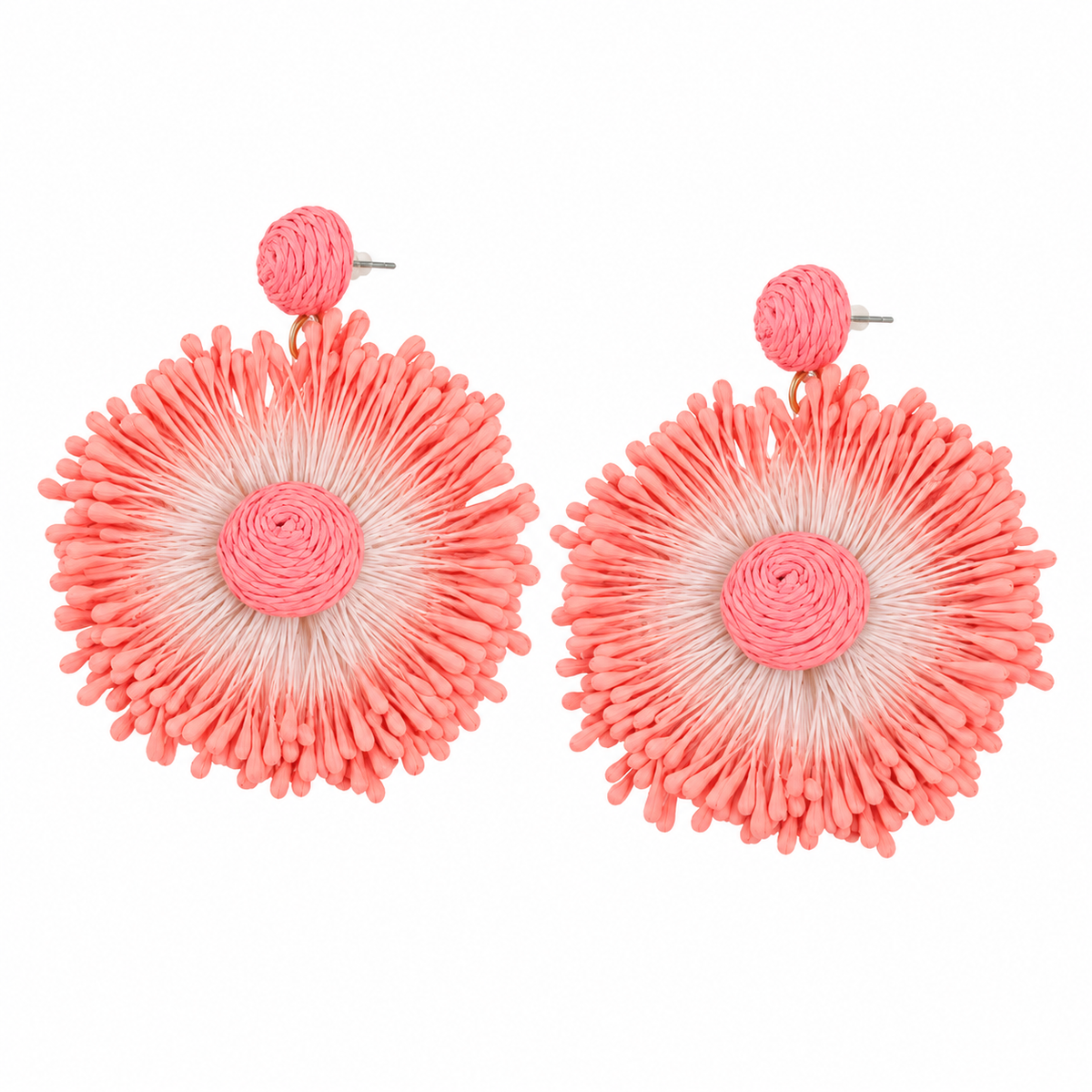 Coral woven sunburst statement earrings on white background