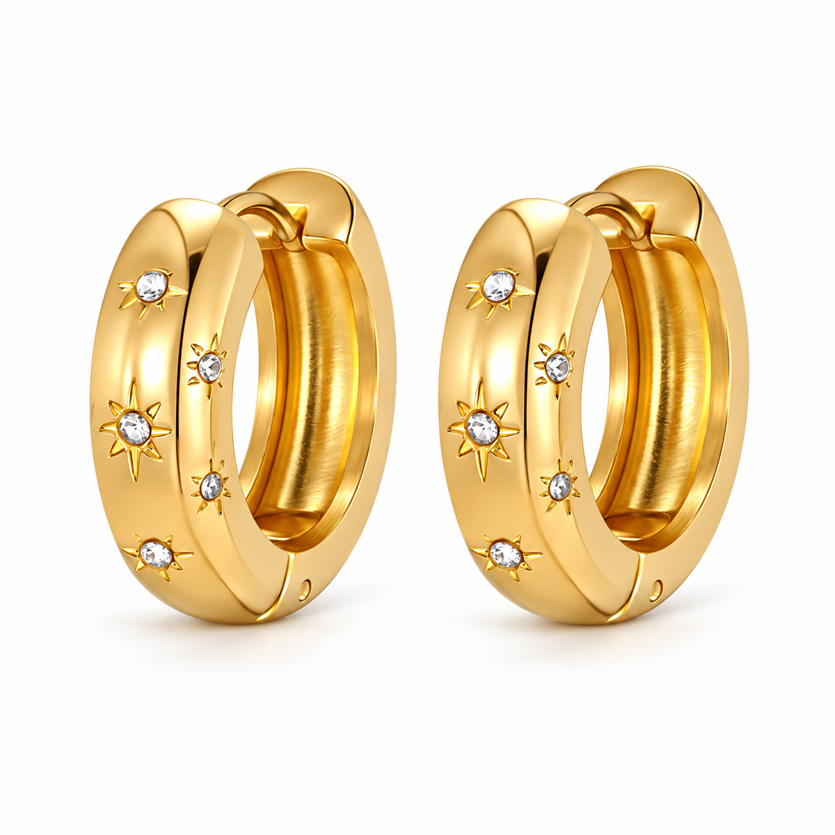 Gold-tone chunky hoop earrings with crystal starburst accents on a pure white background