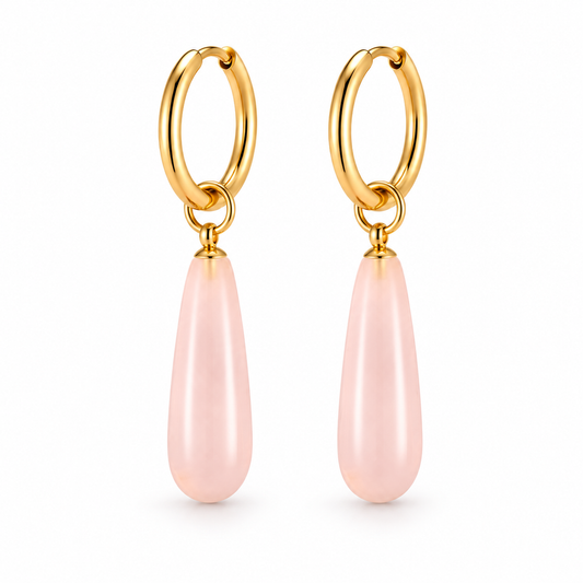 Gold-tone hoop earrings with blush pink natural stone teardrop charms on a pure white background