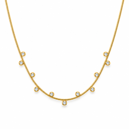 Gold zircon station necklace on white background